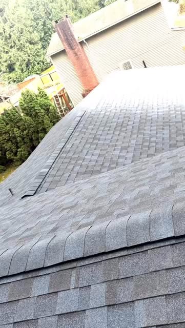 Gray asphalt shingles and a roof ridge detail