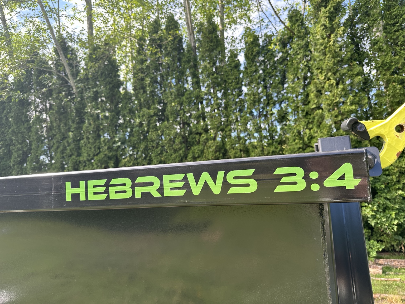 Hebrews 3:4 lettering on our dumpster